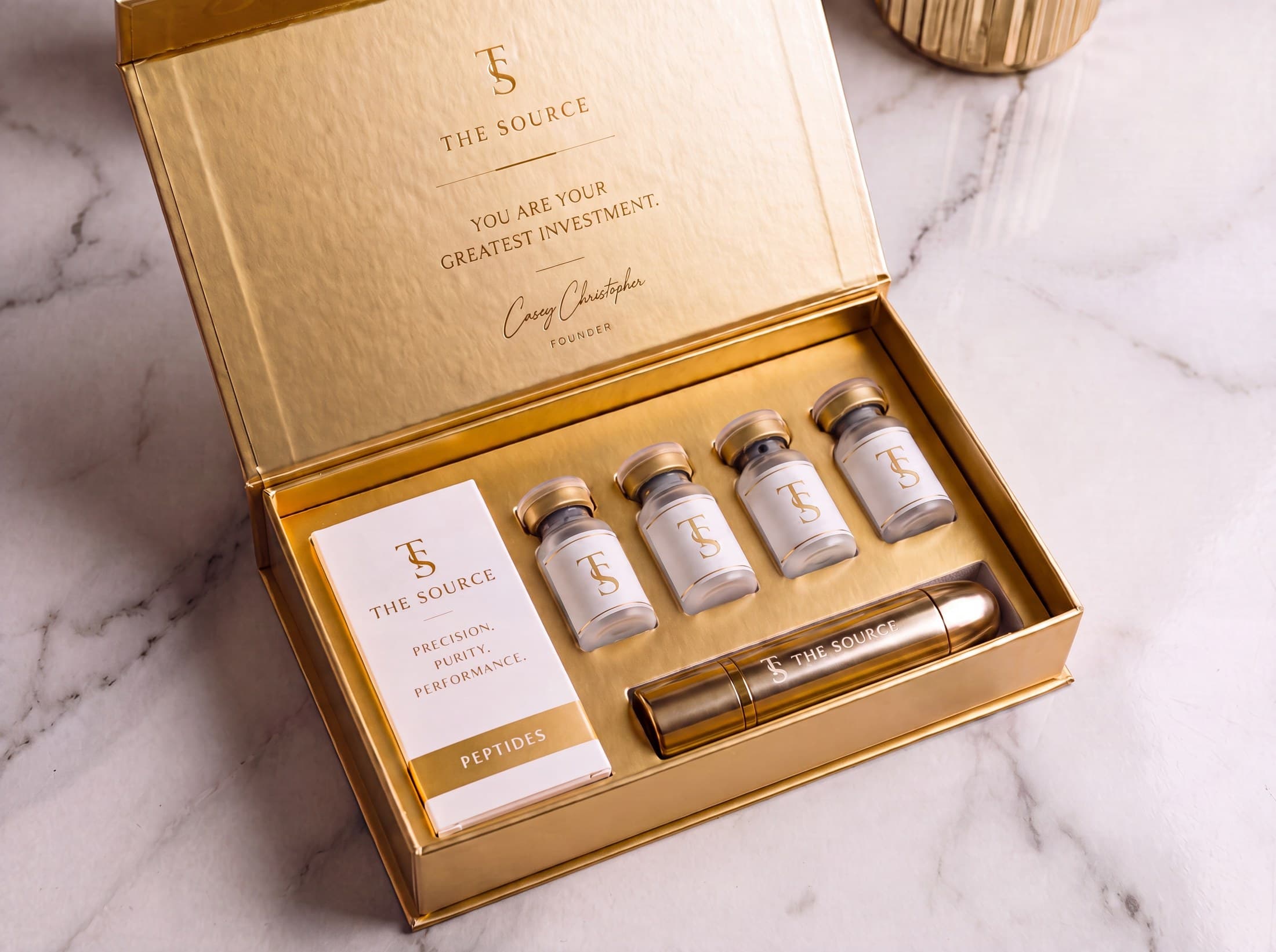 The Foundations Kit — gold-interior box with four house vials and an engraved travel vessel
